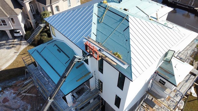 Standing-seam metal roofing installed on a large Gulf Coast home by New Horizon Roofing and Exteriors